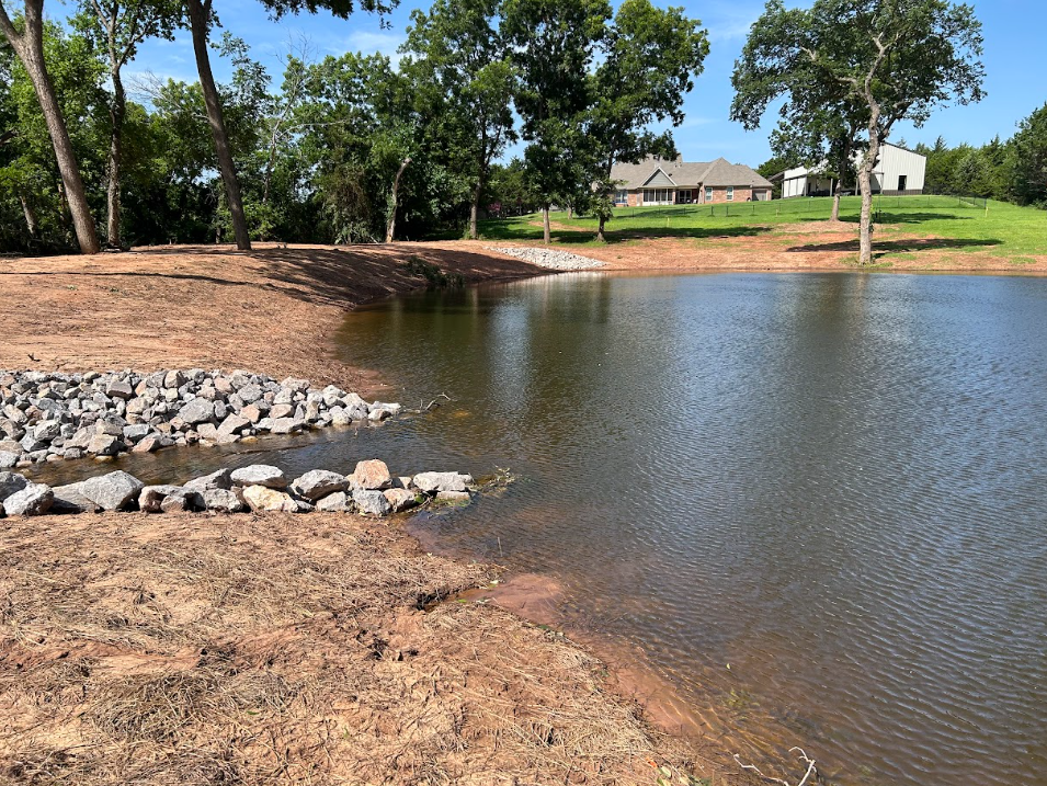 Finished Oklahoma pond full of water on a clear day